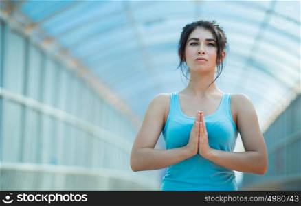 Young mixed woman in the prayer position
