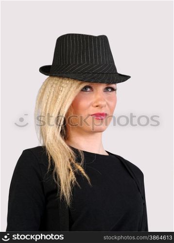 young model in hat on gray background, studio shot
