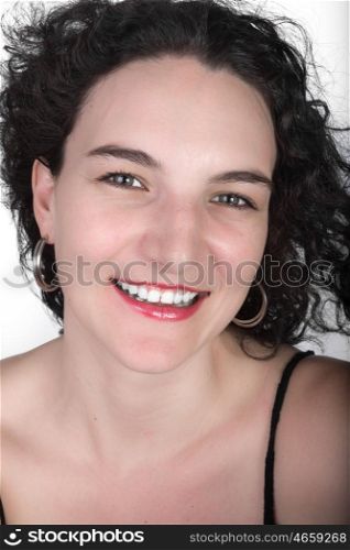 Young model in her mid twenties in a black open shoulder top with a big smile.