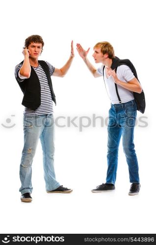Young modern man with mobile showing wait gesture his indignant friend&#xA;