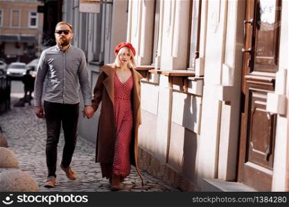 young modern stylish couple urban city outdoors. stylish young couple walking in the city. selective focus.. young modern stylish couple urban city outdoors. stylish young couple walking in the city. selective focus