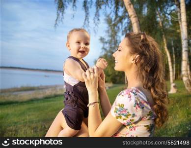 Young mom making her baby laughing