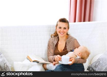 Young mom resting while baby sleep by having coffee and reading book&#xA;
