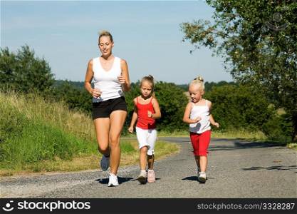 young mom running with two daughters