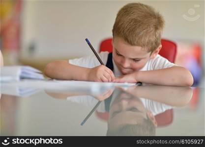 young mom woman doing home work with elementary school grade boy at home in kitchen