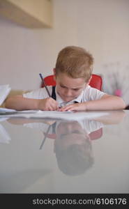 young mom woman doing home work with elementary school grade boy at home in kitchen