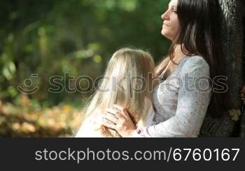 Young mother and daughter having a great sunny day in the park