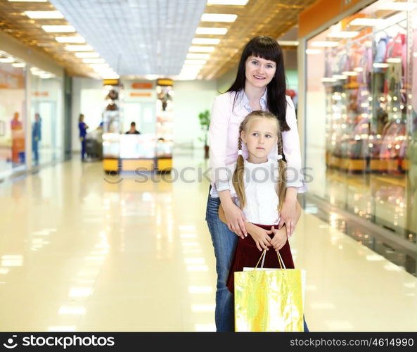 Young mother and her daughter doing shopping together