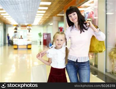 Young mother and her daughter doing shopping together