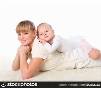 young mother and her little daughter doing sport together indoors