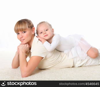 young mother and her little daughter doing sport together indoors