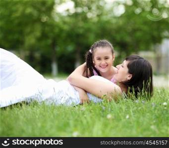 Young mother and her young daughter fun time together outdoors.