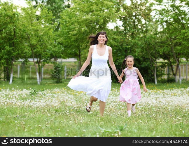 Young mother and her young daughter fun time together outdoors.