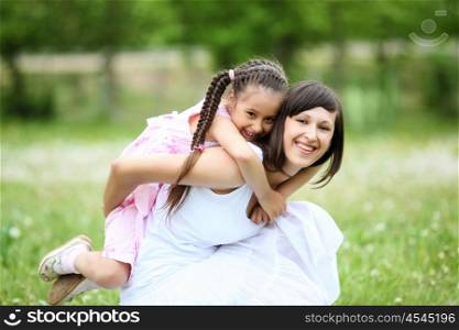 Young mother and her young daughter fun time together outdoors.