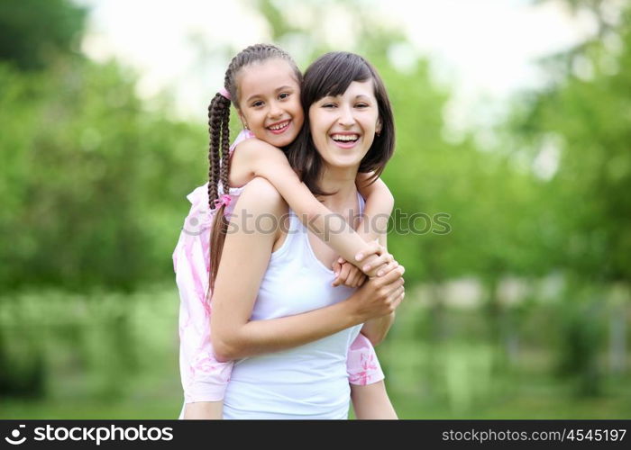 Young mother and her young daughter fun time together outdoors.