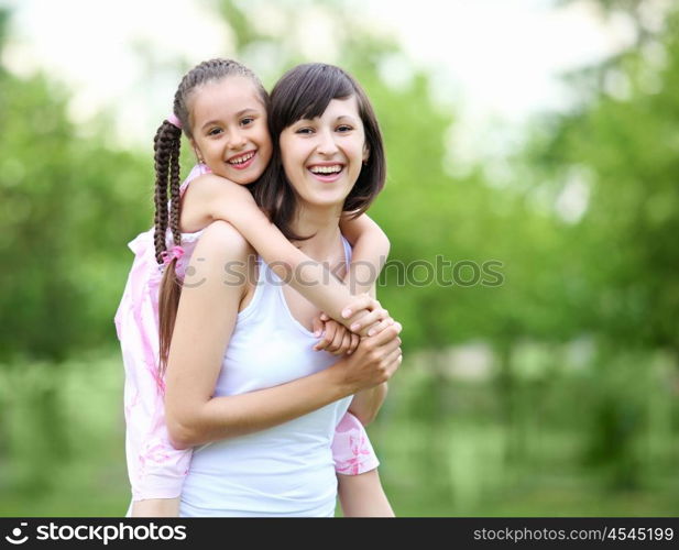 Young mother and her young daughter fun time together outdoors.