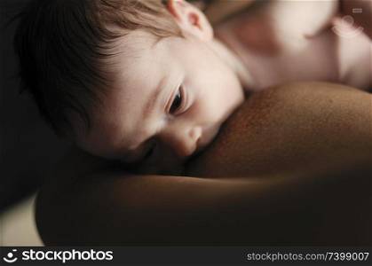 Young mother breastfeeding newborn baby 2 months old at home. Young mother breastfeeding newborn baby at home