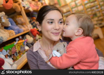 young mother her daughter shopping at the toy store
