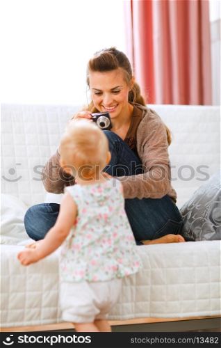 Young mother making photos of baby&#xA;