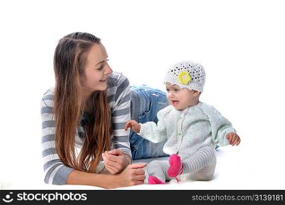 Young mother playing with baby girl on floor
