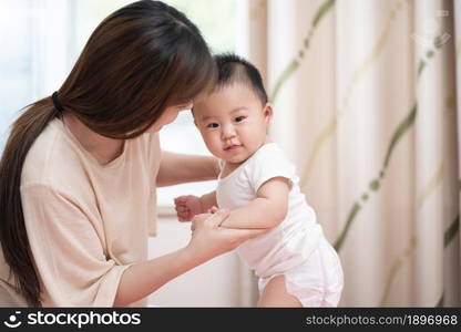 Young mother playing with her baby