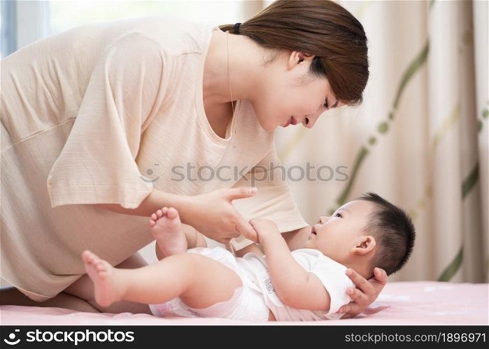 Young mother playing with her baby
