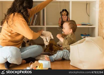 Young Mother playing with toddler at home