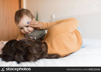 Young Mother playing with toddler at home