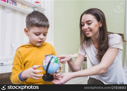 young mother teaching son