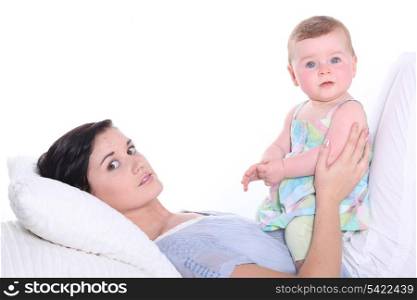 young mother with baby in bed