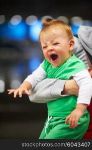 young mother with baby in shopping mall supermarket store buying food and grocery