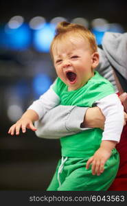 young mother with baby in shopping mall supermarket store buying food and grocery