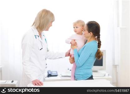 Young mother with baby visiting pediatric doctor
