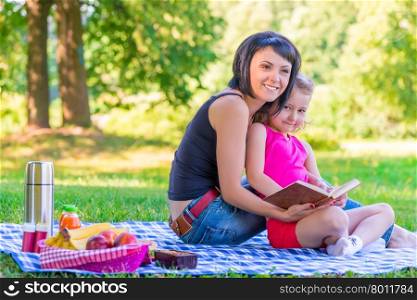 young mother with her daughter at a picnic