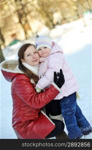 young mother with her daughter. winter day