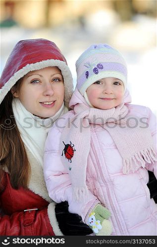 young mother with her daughter. winter day