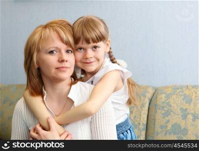 young mother with her little daughter together at home