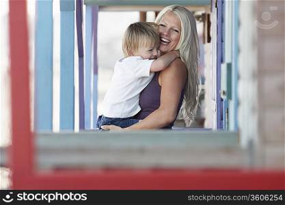Young mother with son (3-4) on outdoor porch