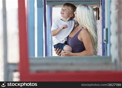 Young mother with son (3-4) on outdoor porch