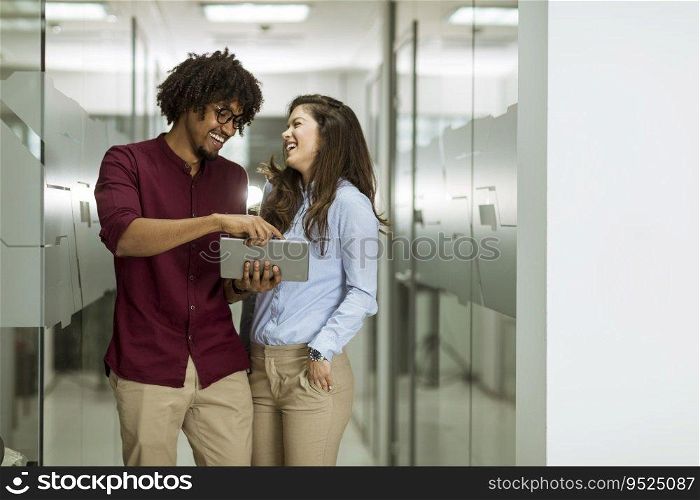 Young multiethnic business couple using a digital tablet in the office