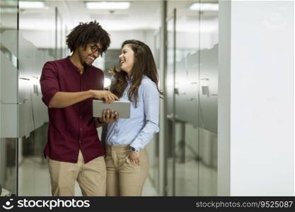 Young multiethnic business couple using a digital tablet in the office