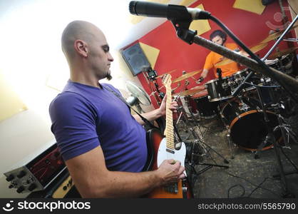 young music player and band friends have training in home garage