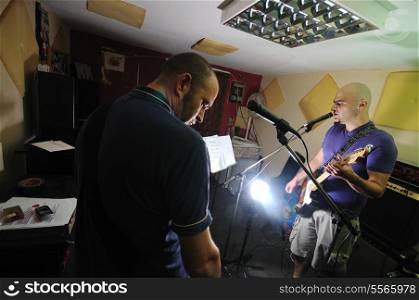 young music player and band friends have training in home garage