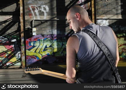 young music player playing guitar instrument