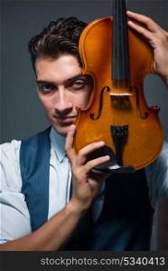 Young musician man practicing playing violin at home