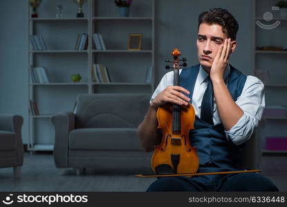 Young musician man practicing playing violin at home. The young musician man practicing playing violin at home