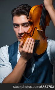 Young musician man practicing playing violin at home