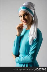 Young muslim girl on grey