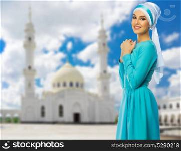 Young muslim woman at mosque background