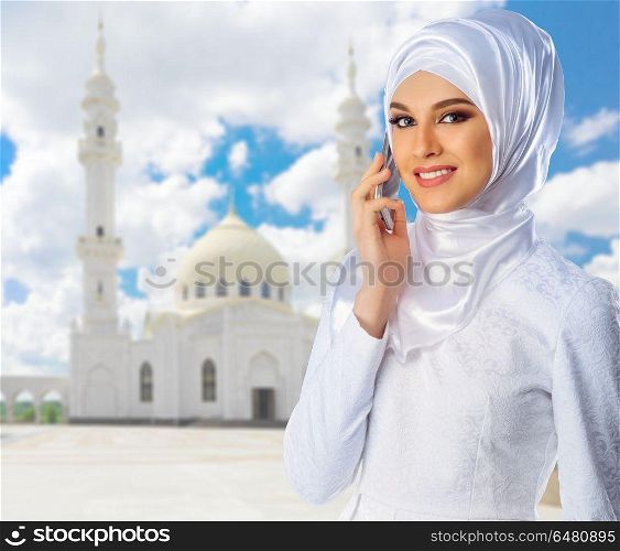 Young muslim woman on white mosque background. Muslim woman on white mosque background